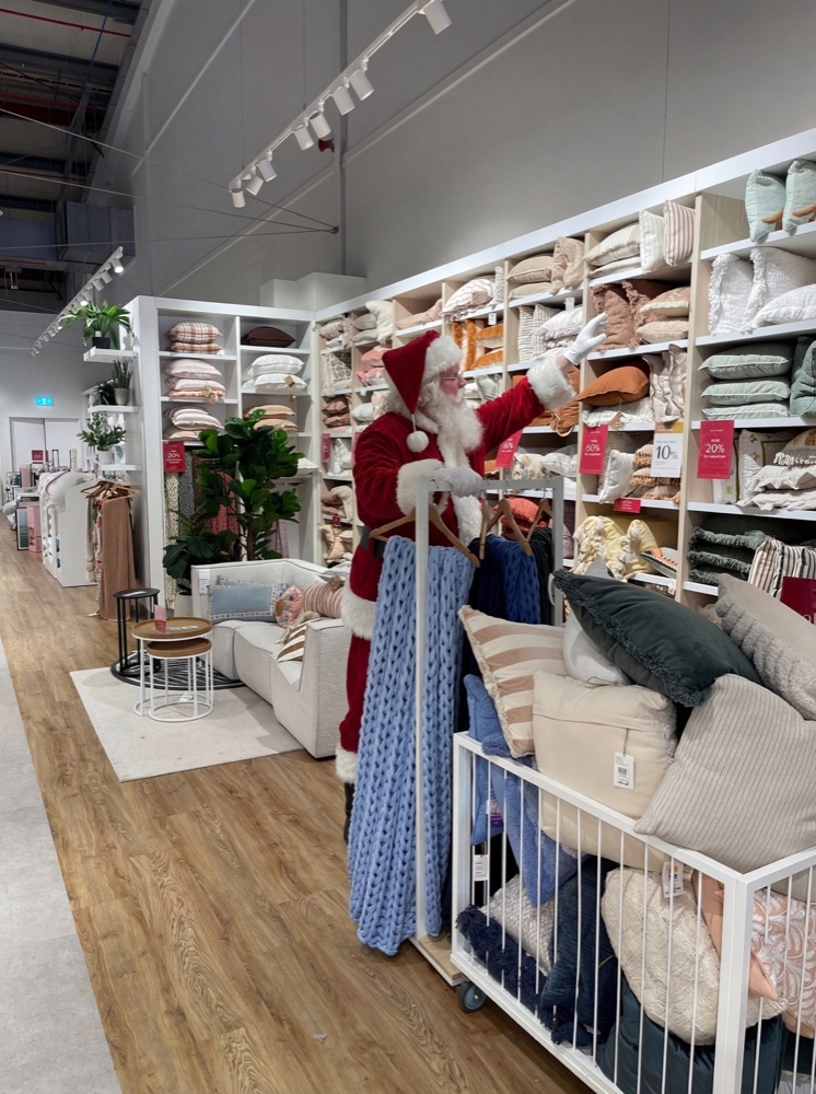 Santa shopping, reaching up for a pillow