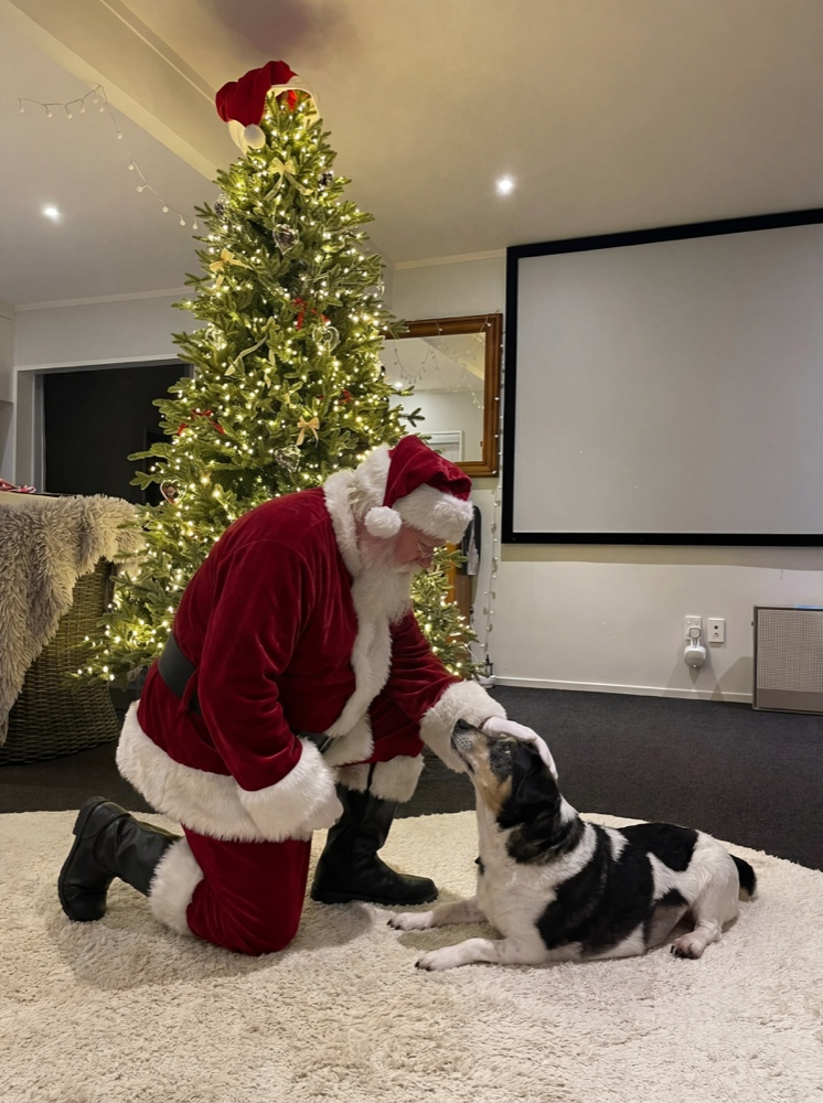 Santa petting the dog
